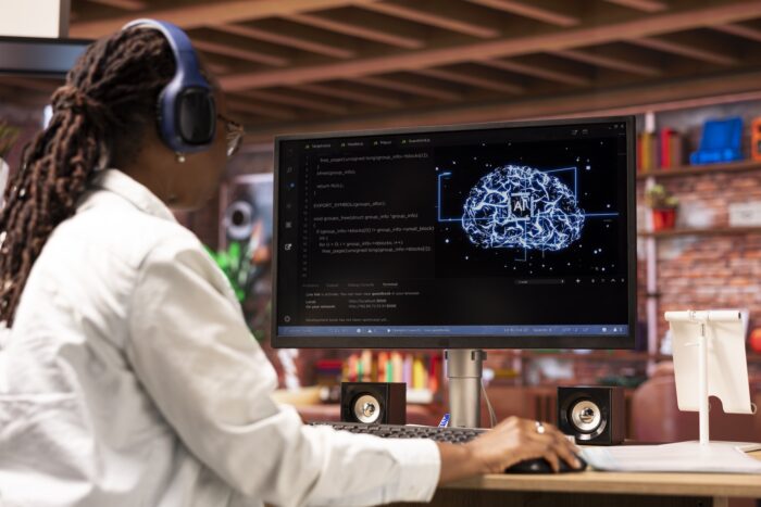 Female developer wearing headphones, doing checkup on AI systems