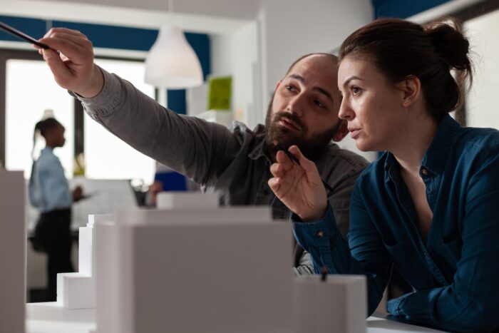 Developers looking towards a computer screen.