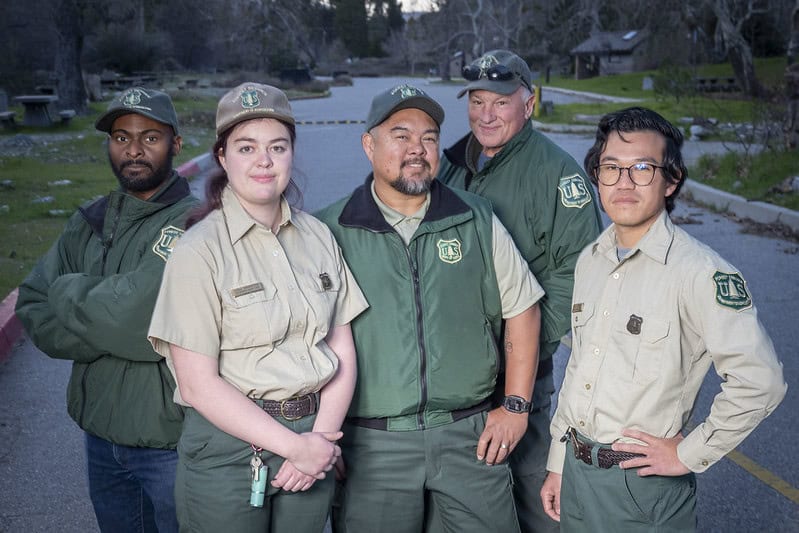 (L to R) U.S. Forest Service Reality Specialist Gordon Chike, Environmental engineer Luisa Bannister, Recreation Fee Program Manager Jonar Rodrigo, Recreation Tech. Willis S. Adams Jr. , and Transportation Engineer Christopher SooHoo post at the Applewhite picnic area on the San Bernardino National Forest, in Lytle Creek