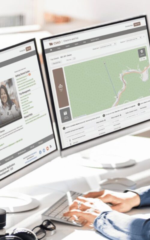 woman staring at two computer screens