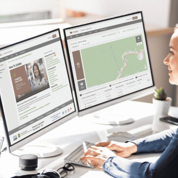 woman staring at two computer screens