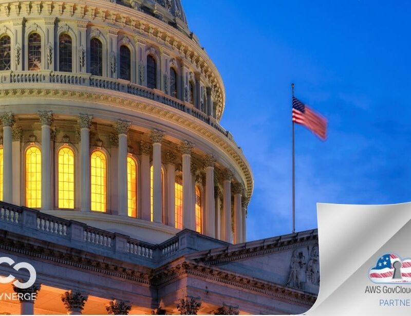US Capitol with US Flag flying on flag pole with the Cynerge logo on the bottom left and the AWS GovCloud (US) cloud badge on the bottom right.
