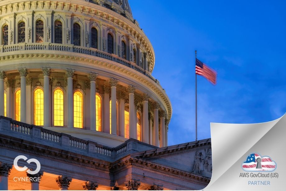 US Capitol with US Flag flying on flag pole with the Cynerge logo on the bottom left and the AWS GovCloud (US) cloud badge on the bottom right.