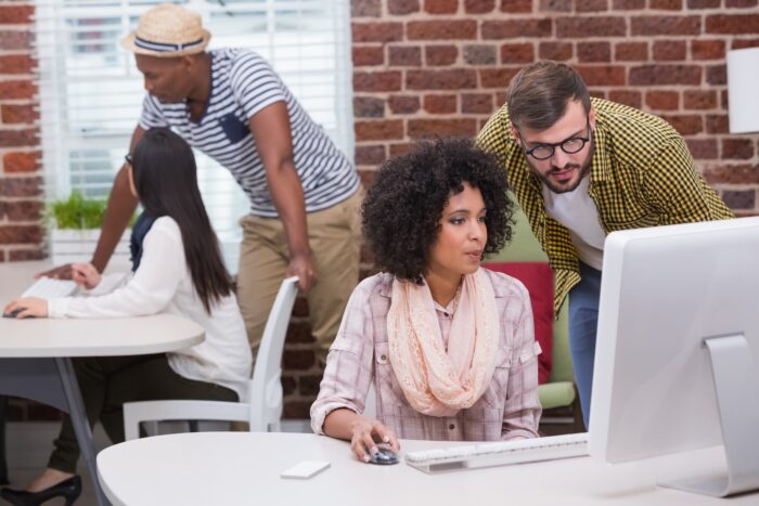 Developers sitting at desks looking at their computer screens.